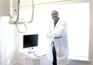 Dr. O'Neal standing by his cerec machine